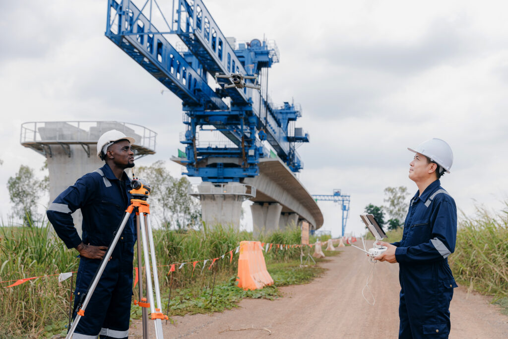 Engineer surveyor team Use drone for operator inspecting and survey construction site. Surveyors or explorer use drones to view construction sites or check security